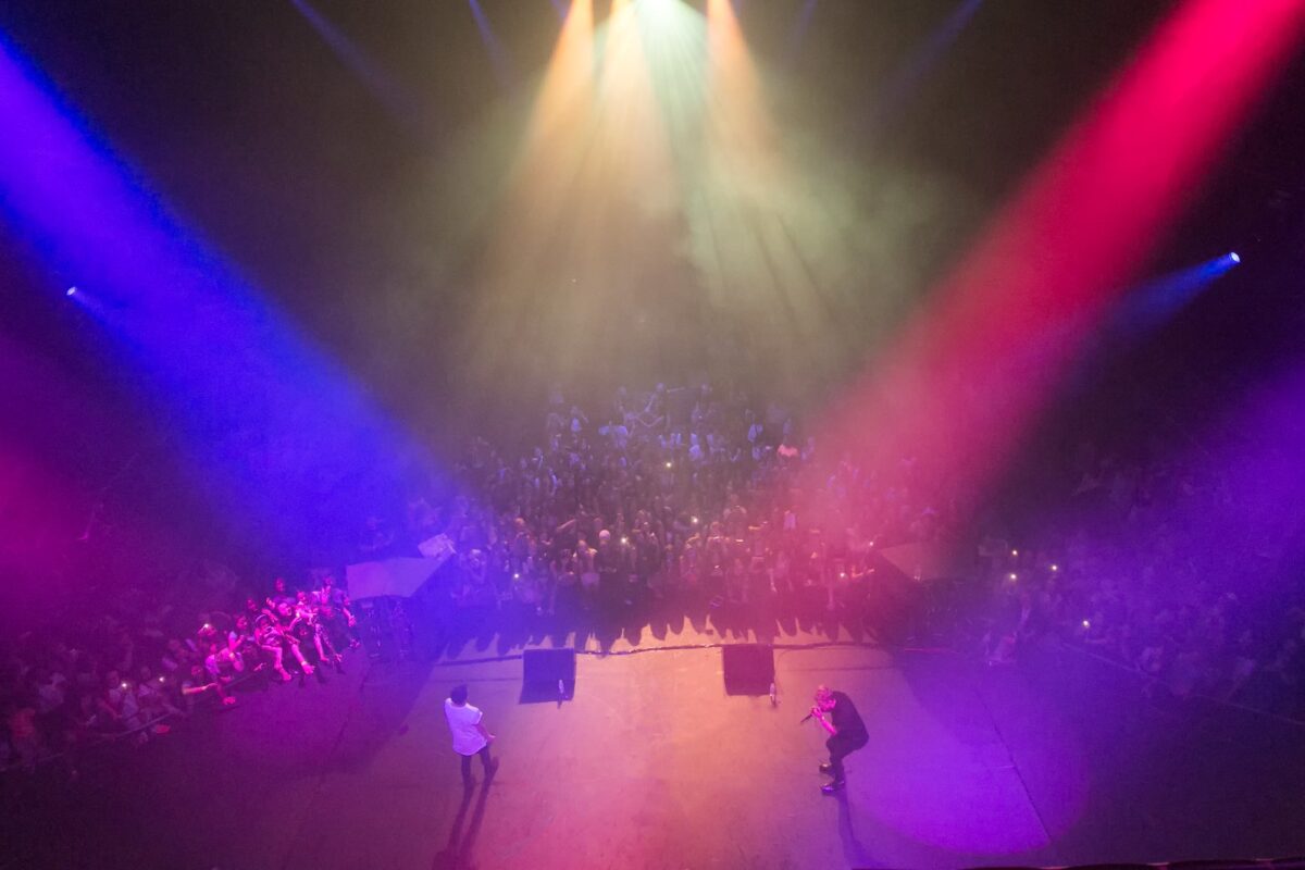 red and blue floodlights onto a stage of musicians
