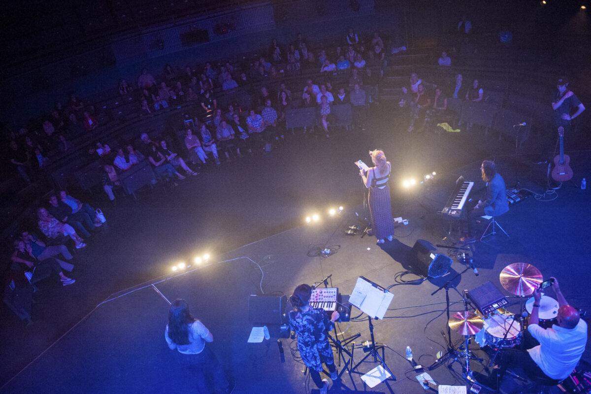 An aerial view of a band performing to an audience in Rose Theatre